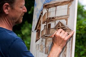 artist painting on canvas