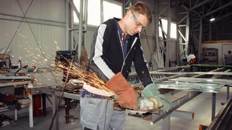 master works on a grinding machine