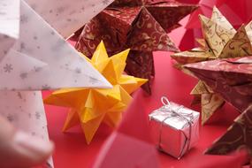 Beautiful and colorful brascetta stars and gift, at red background