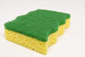 Yellow and green house work sponge on the white surface