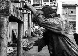 worker near water in black and white background