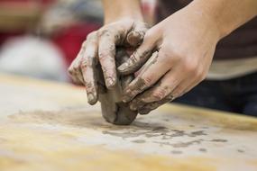 girl working with clay on the table