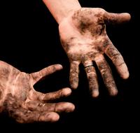 dirty hands with ring on black background