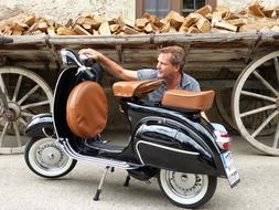 photo of Man and Vespa Roller