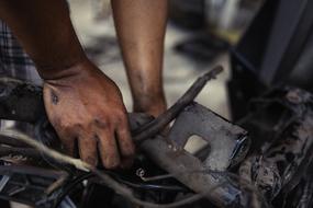 Dirty male Hands Working with metal