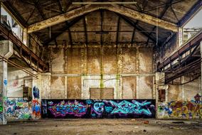 graffiti and dirt on the walls of an abandoned factory