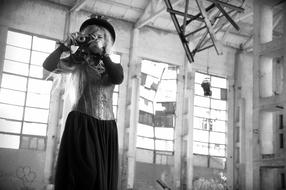 black and white photo of a girl photographer in a destroyed plant