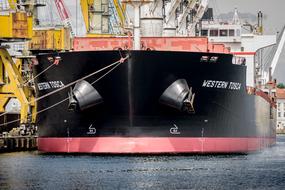 front view of the black and red General Cargo Ship in harbor