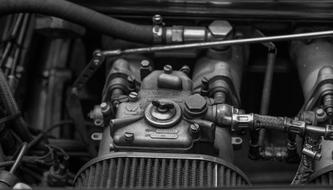 black and white photo of a carburetor in a car