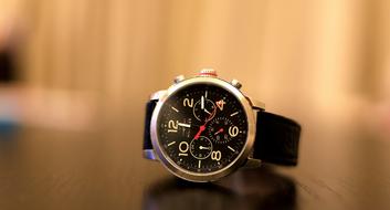 black men's watch lies on the table