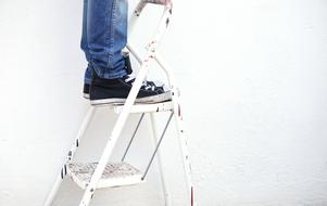 male legs on Ladder at wall