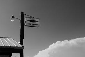 self parking sign with ufo drawing on pole, usa, nevada