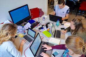 group of students working on laptops together