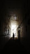 man in an abandoned factory tunnel