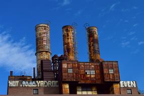 Industrial factory on background with blue sky with clouds