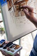 street artist paints in watercolor