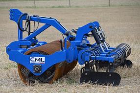 Close-up of the blue and black tractor on the beautiful, yellow field