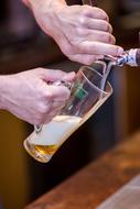 a man pouring beer into a glass
