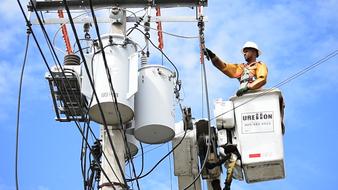 electrician repairing outdoor power line