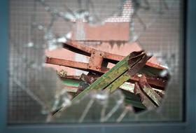 view of steel beams through broken glass