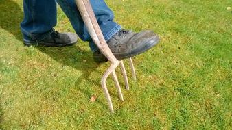 farmer's foot on pitchfork