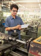 young Worker reading paper in workshop