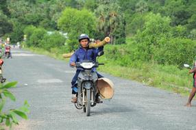 farmer on motorbike in Cambodia