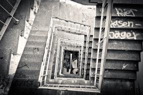 Black and white photo of the old abandoned staircase with graffiti