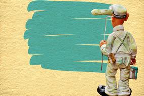 Figure of a painter, near the turquoise paint on the yellow wall, clipart