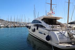 white yacht in the harbor on a sunny day