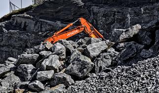 Digger at pile of Rocks