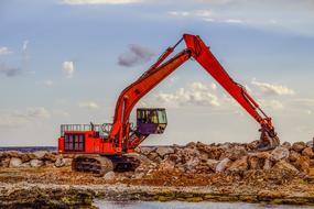 Heavy hydraulic Excavator digging rocks