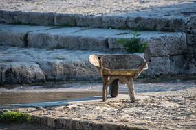 garden wheelbarrow on the shore of the reservoir