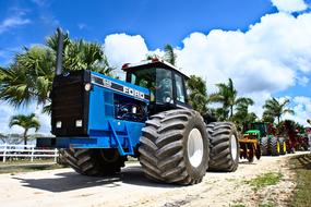 big blue tractor on a sunny day