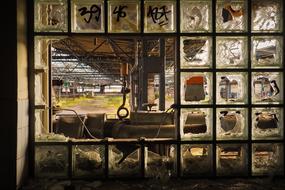 broken windows in an abandoned factory building