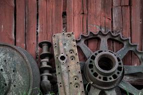metal wheels near a wooden wall