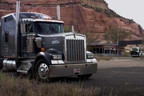 photo of a large chrome truck on the road