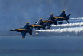 Blue Angels Aircrafts with traces in flight above the water