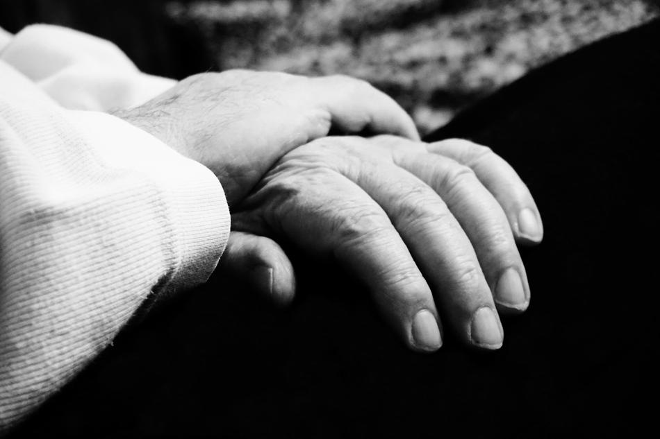 folded hands of elderly person