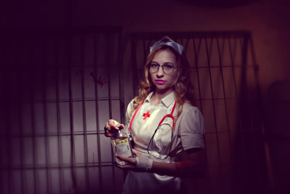 Woman in Nurse costume with the bottle