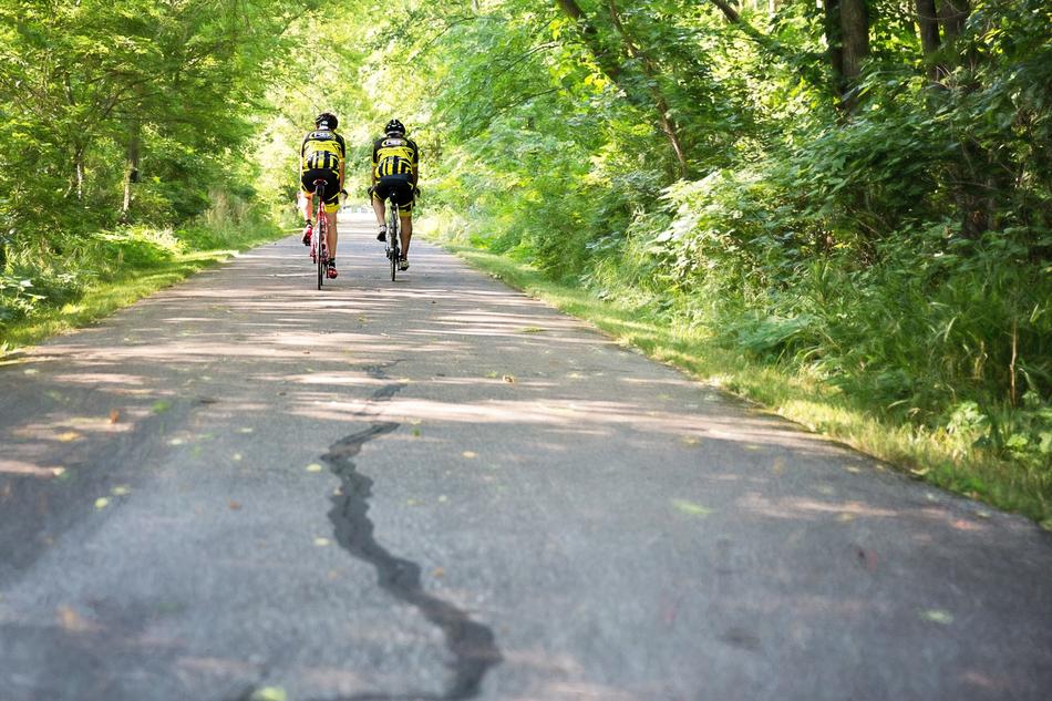 Two person on the Bicycles among the plants