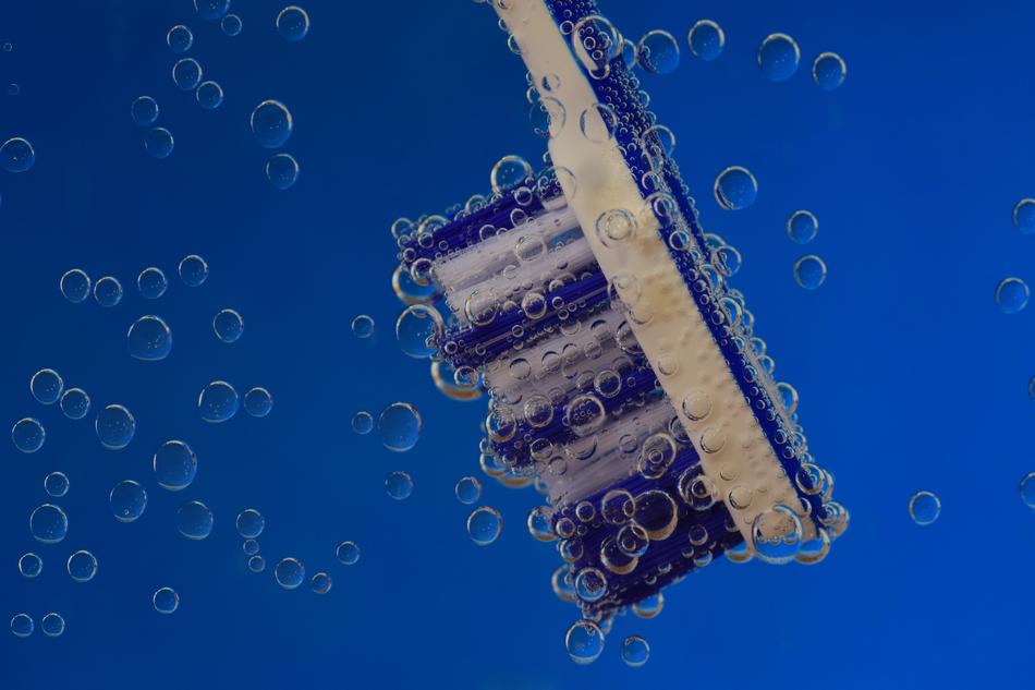 Toothbrush among the bubbles in water