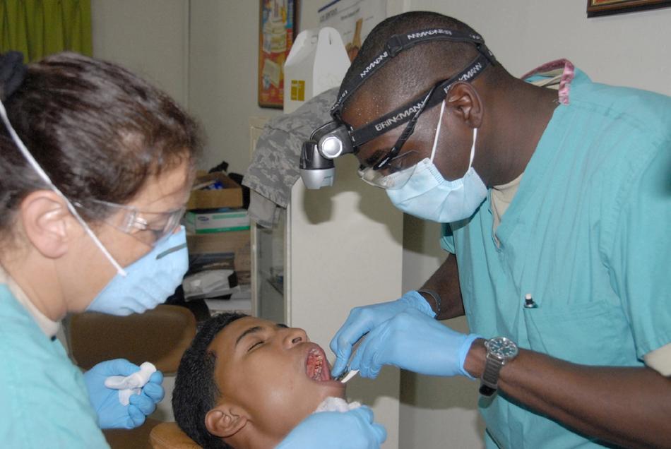 Dentists working with dark skin patient