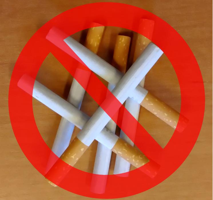clipart of red prohibition sign on a photo of cigarettes