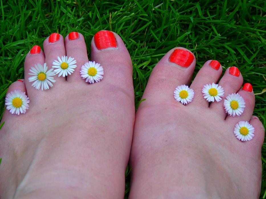 toes with bright orange nail varnish