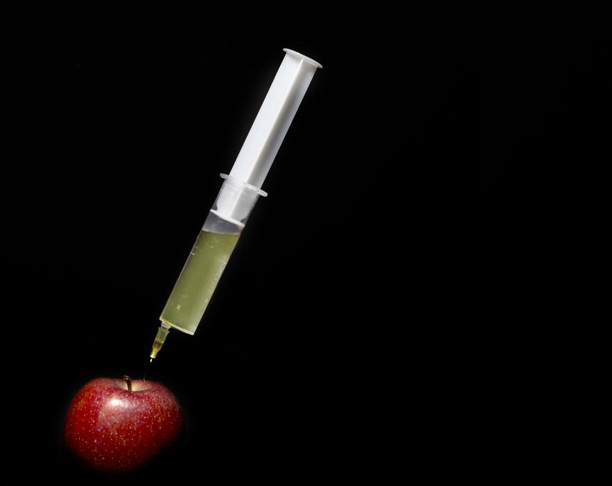 syringe in apple