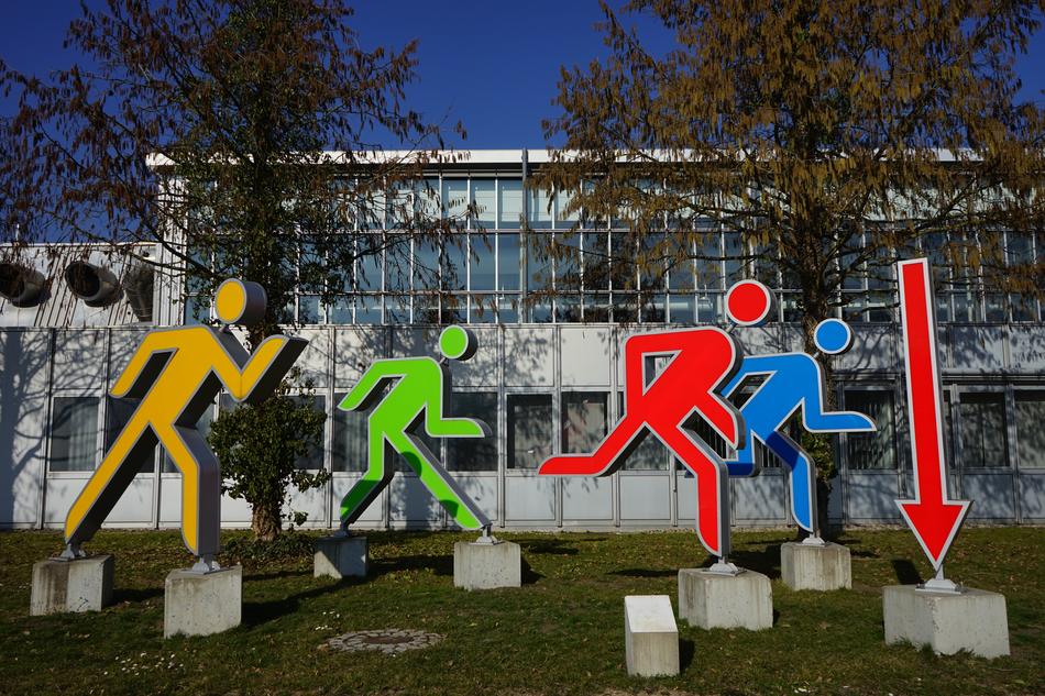 Males Jog Group as a colorful sculptures in front of the building