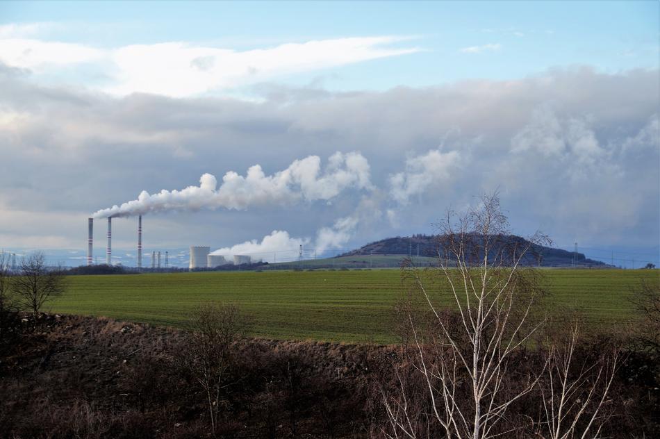 green field in the background breathing from the pipes of the plant