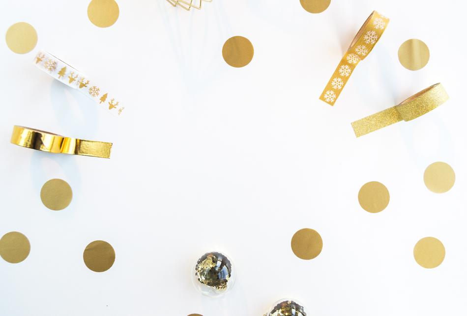 Beautiful, patterned gold ribbons, circles and balls on the white surface
