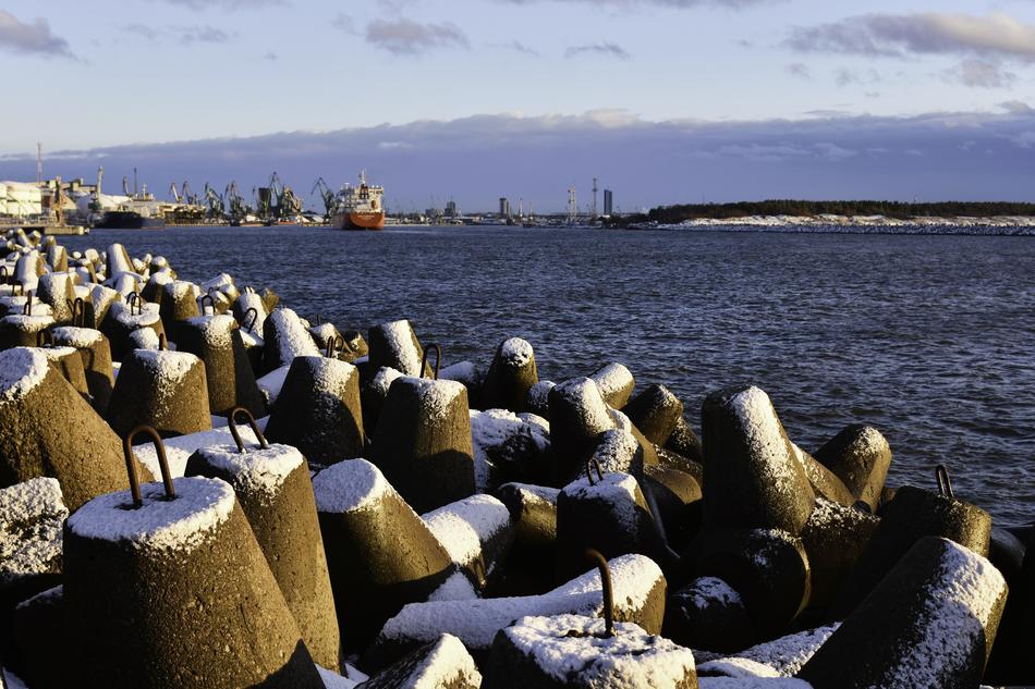 Beautiful port in white snow, in light, in Lithuania, with the blue water